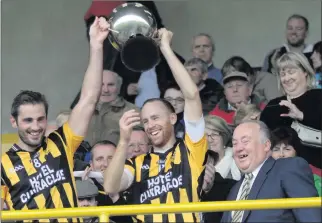  ??  ?? ■ Joint captains Brian Malone and Aidan Cash after receiving the cup from Noel O’Keeffe.