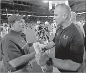  ?? File, Wilfredo Lee / AP ?? FSU head coach Jimbo Fisher (left) and Miami head coach Mark Richt meet after last year’s game in Miami.