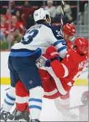  ?? Associated Press photo ?? Winnipeg Jets defenceman Dustin Byfuglien (33) collides with Detroit Red Wings centre Frans Nielsen (51) in front of the net during the first period of an NHL hockey game Friday in Detroit.