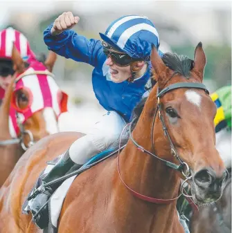  ?? Picture: COLLEEN PETCH ?? Jockey Regan Bayliss celebrates a Flemington win on Faatinah.