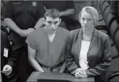  ?? SUSAN STOCKER/SOUTH FLORIDA SUN-SENTINEL VIA AP, POOL ?? A VIDEO MONITOR SHOWS SCHOOL SHOOTING SUSPECT Nikolas Cruz (left) making an appearance before Judge Kim Theresa Mollica in Broward County Court, on Thursday in Fort Lauderdale, Fla.