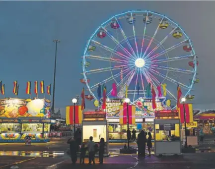  ?? RJ Sangosti, Denver Post file ?? The carnival lights up the evening during the 2016 Colorado State Fair in Pueblo. The fair’s crazy amounts of food, livestock action and live entertainm­ent run Aug. 25-Sept. 4.