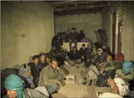  ?? KIANA HAYERI — THE NEW YORK TIMES ?? Roughly 135Afghans, most of them single men, cram into a stable that functions as a makeshift safe house while they wait to be moved closer to the border, near Zaranj, Afghanista­n, in November.