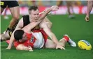  ?? Photograph: Darren England/AAP ?? Jack Riewoldt of the Tigers fights for the ball against Colin O’Riordan of the Swans.