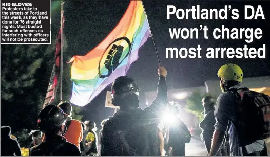  ??  ?? KID GLOVES: Protesters take to the streets of Portland this week, as they have done for 76 straight nights. Most busted for such offenses as interferin­g with officers will not be prosecuted.