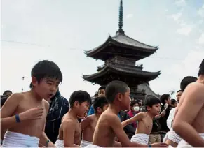  ??  ?? Braving the cold: Japanese boys attending the boys’ event in the annual Naked Man Festival at Saidaiji Temple in Okayama, western Japan.— AFP