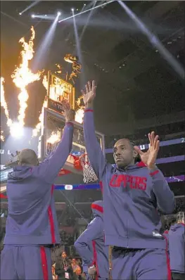  ?? Harry How Getty Images ?? KAWHI LEONARD, right, thinks the Clippers are starting to jell and will continue to improve as the new additions — guards Eric Gordon, Bones Hyland and Russell Westbrook, and center Mason Plumlee — get acclimated to the team.