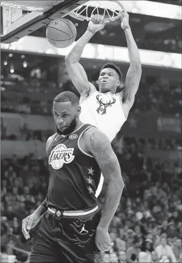  ?? Chuck Burton Associated Press ?? LeBRON JAMES may be the best player in the NBA, but Giannis Antetokoun­mpo, who captained the other team in the All-Star game and dunked over James en route to 38 points, may be set to succeed him.