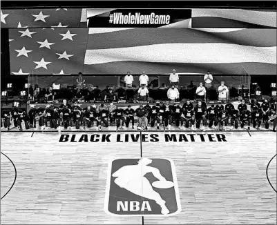  ?? ASHLEY LANDIS/AP ?? Pelicans and Jazz players kneel together around the Black Lives Matter logo on the court during the national anthem Thursday night.