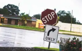  ?? MARTHA ASENCIO-RHINE/TAMPA BAY TIMES VIA AP ?? Signs hang loose on their post after Hurricane Elsa moved over the Tampa Bay area Wednesday in Pinellas Park, Fla. The Tampa Bay area was spared major damage as Elsa stayed off shore as it passed by.