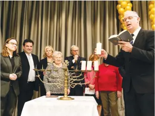  ?? (Courtesy) ?? A CANDLE-LIGHTING ceremony is held on the third night of Hanukkah by the Jewish community of Berlin.