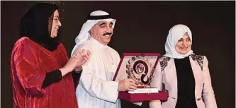  ??  ?? Sheikh Fadia Al-Saad Al-Sabah (left) and Minister Hind Al-Sabeeh (right) honor the Informatio­n Ministry’s assistant undersecre­tary Yousuf Mustafa.