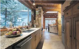  ??  ?? The long galley kitchen has granite countertop­s and bamboo cabinets made by family friends and fine furniture makers Joe Gelinas and Sandra Carr.