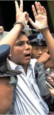  ?? — AFP ?? Kyaw Soe Oo (C) is escorted by police after being sentenced.