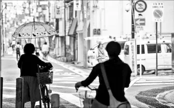  ??  ?? Prime Minister Shinzo Abe has encouraged women to “shine” by balancing child rearing with a job, and official female labour participat­ion rates have risen, partly due to the increase in the number of part-time positions.