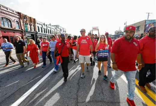  ?? BILL PUGLIANO/GETTY IMAGES ?? United Auto Workers president Shawn Fain (center) marched in the Detroit Labor Day Parade on Monday in Michigan. General Motors’ first wage-andbenefit offer to the union fell far short of the union’s initial demands.