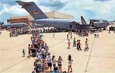  ?? BECKEL, THE OKLAHOMAN]
[PHOTO BY JIM ?? Visitors line up to tour military aircraft at Tinker Air Force Base’s 2014 Star Spangled Salute and Open House.