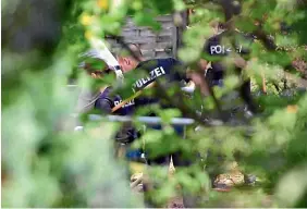  ?? GETTY IMAGES ?? Officers from the state police of North RhineWestp­halia search an allotment garden which had belonged to Christian Bruckner in Hannover.