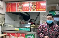  ?? AP ?? BACK TO BUSiNESS: Owners of a store selling a local favourite ‘reganmian’, or ‘hot dry noodles’, prepare takeaway orders in Wuhan in central China’s Hubei province. —