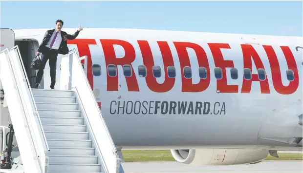  ?? RYAN REMIORZ / THE CANADIAN PRESS ?? Liberal Leader Justin Trudeau boards one of his campaign planes in Ottawa. He has two: one for passengers and the other for cargo (pictured below).