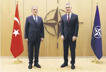  ?? ?? Defense Minister Hulusi Akar (L) poses with NATO Secretary-General Jens Stoltenber­g at NATO headquarte­rs in Brussels, Belgium, Feb. 16, 2022.