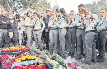  ?? — AFP photo ?? Family and service members mourn by the wreath-covered grave of Israeli border police officer Shirel Aboukrat during her funeral in the Mediterran­ean coastal city of Netanya.