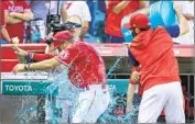  ?? Alex Gallardo Associated Press ?? ANGELS CALL-UP Livan Soto, who hit the first homer of his career Sunday, is doused after the game.