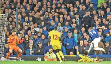  ??  ?? Everton’s Turkish striker Cenk Tosun (R) shoots to score their second goal past Crystal Palace’s Welsh goalkeeper Wayne Hennessey during the English Premier League football match between Everton and Crystal Palace at Goodison Park in Liverpool, north west England. - AFP photo