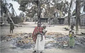  ?? Photos: Marco Longari/afp & Zinyange Auntony/afp ?? Attacked: From Muidumbe to Macomia (above), Islamists have burned villages, leaving 40 000 people homeless. On Ibo island Mansuri Juma (below) waits outside a mosque for the military advances the country’s president has promised.