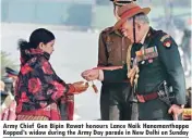  ??  ?? Army Chief Gen Bipin Rawat honours Lance Naik Hanamantha­ppa Koppad’s widow during the Army Day parade in New Delhi on Sunday