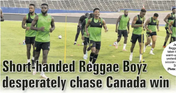  ?? (Photo: Karl Mclarty) ?? Jamaica’s Reggae Boyz are taken through their warm-up drills during yesterday’s practice session at the National Stadium.