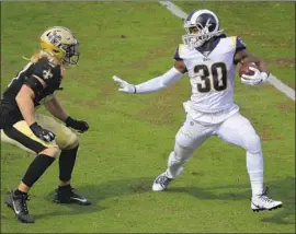  ?? Mark J. Terrill Associated Press ?? RAMS RUNNING BACK Todd Gurley (30) wards off New Orleans linebacker Alex Anzalone during Sunday’s victory. “Just something natural,” Gurley says.