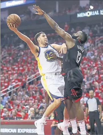  ?? NHAT V. MEYER — STAFF PHOTOGRAPH­ER ?? Klay Thompson, who scored 23points, tries to get a shot up and over the Rockets’ James Harden in the first quarter.