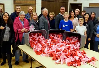  ??  ?? Volunteers made tubs full of Origami flowers for Valentine’s Day at Spanish Fork High School.