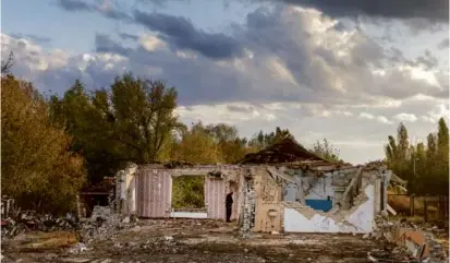  ?? DAVID GUTTENFELD­ER/NEW YORK TIMES ?? A Ukrainian villager viewed ruins after a Russian rocket attack in Hroza, Ukraine, on Oct. 6. A UN official cited “horrendous humanitari­an consequenc­es” in Ukraine from the war.