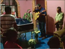  ?? BRETT GUNDLOCK / THE NEW YORK TIMES ?? People attend a wake for Juan Jiménez, a policeman killed when half of Juchitán de Zaragoza’s City Hall collapsed, at his wake Saturday in the town in the state of Oaxaca, Mexico.