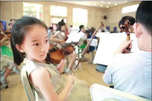  ?? PHOTOS BY FENG YONGBIN / CHINA DAILY ?? Children practice different musical instrument­s during a 10-day music camp in Beijing. The non-profession­als will give a performanc­e at the Beijing Concert Hall on Monday.