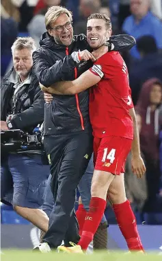  ?? — AFP photo ?? Liverpool’s German manager Jurgen Klopp celebrates with Liverpool’s English midfielder Jordan Henderson following the English Premier League football match between Chelsea and Liverpool at Stamford Bridge in London on September 16, 2016.