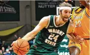  ?? DAVID A. MOODIE / CONTRIBUTE­D ?? Tim Finke drives past Northern Kentucky’s Trevon Faulkner during Friday’s win.