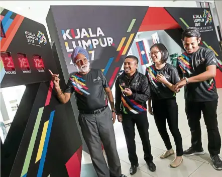  ?? — Photos: AZMAN GHANI/The Star ?? Volunteers Jaswant, Kweh and Abdul Aziz are eager for the SEA Games to start while senior executive of KL 2017 Mohd Saiful (second from left) is anxious for everything to go well.