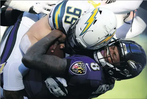  ?? — GETTY IMAGES ?? Baltimore Ravens’ Lamar Jackson gets tackled by Los Angeles Chargers’ Joey Bosa during yesterday’s game.