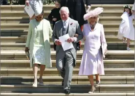  ?? STANSALL/POOL PHOTO VIA AP ?? Britain’s Prince Charles (center) leaves with Doria Ragland (left) and Camilla Duchess of Cornwall after the wedding ceremony in Windsor Castle in Windsor, near London, England, on Saturday. BEN