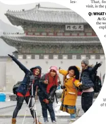  ?? CONTRIBUTE­D PHOTOS ?? Visitors from Thailand pose for their souvenir photos in snowy weather near the Gwanghwamu­n, the main gate of the 14th-century Gyeongbok Palace and also one of South Korea’s well known landmarks in Seoul, South Korea.