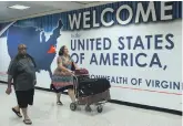  ?? AFP ?? Travellers leave immigratio­n at Dulles Internatio­nal Airport in Virginia