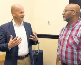  ?? ?? Rob Eyers (left), Unified Technology’s senior vice president, business developmen­t for the English-speaking Caribbean, Unified Technology, in conversati­on with Garfield Gordon (right,) IT technology consultant.