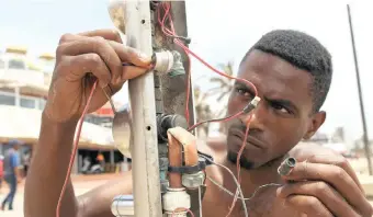 ?? BONGANI MBATHA African News Agency (ANA) ?? NJABULO Zondi takes a look at the exposed wires from one of the showers at North Beach which have not worked in months. |