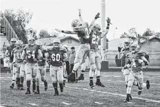  ?? STACIE SCOTT/AZCENTRAL SPORTS ?? Yuma Catholic celebrates its win over Eagar Round Valley in the Division V state championsh­ip game at North Canyon High on Saturday.