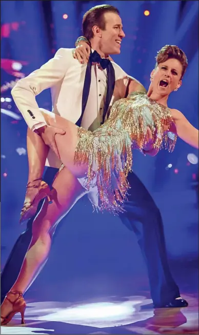  ??  ?? Golden glamour: Katie Derham wows audience and judges in her dance with Anton Du Beke