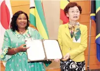  ?? ?? First Lady Dr Auxillia Mnangagwa and Vice Chair Mrs Fukuyo Nakamori display the declaratio­n she signed together with other African First Ladies committing themselves to ensuring sustainabl­e food production and provision of clean water among other necessitie­s to chil dren during the 1st Asia Pacific Africa Women’s Economic Exchange Summit in Tokyo, Japan, yesterday