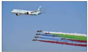  ?? (AP) ?? An Etihad Boeing 787 Dreamliner flies alongside the Emirati Forsan military stunt flying team at the Dubai Air Show in Dubai, United Arab Emirates in 2021.